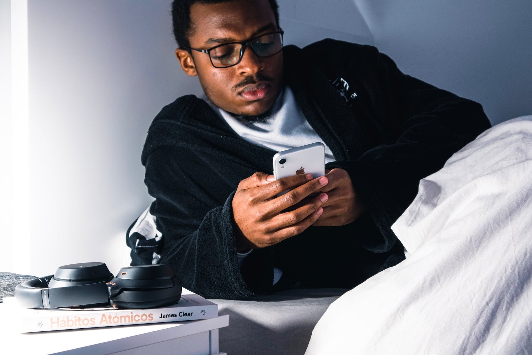 a man in bed on his phone