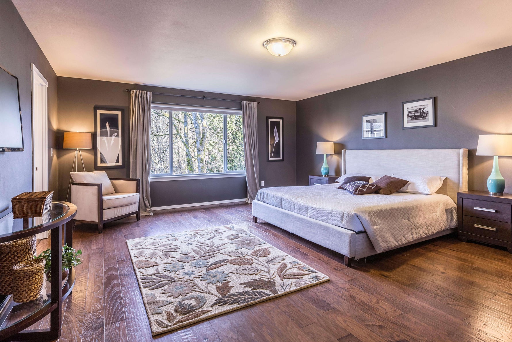Clean bedroom decorated in purple and dark gray