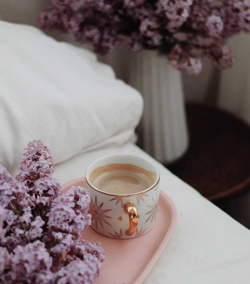 White Bed with Romantic Lilac Flowers and Pink Tray 
