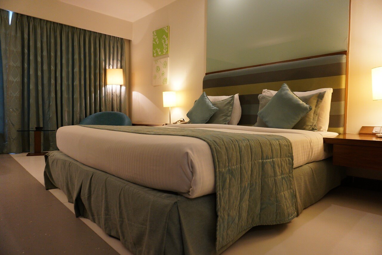 bed with green and tan bedding