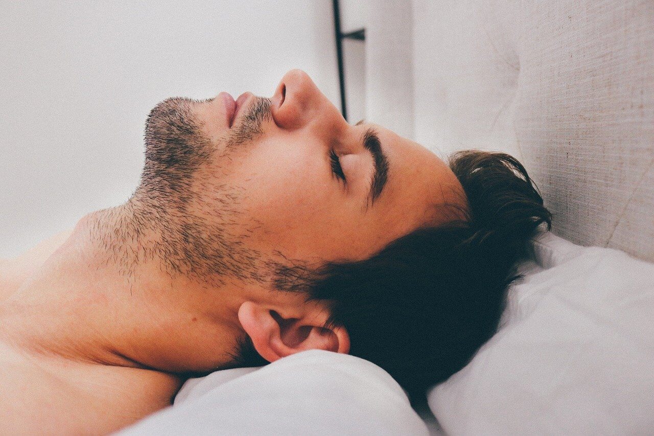  young man lying down in bed