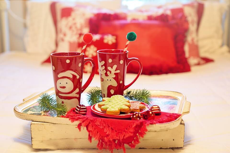  mugs and cookies on holiday-themed bedding